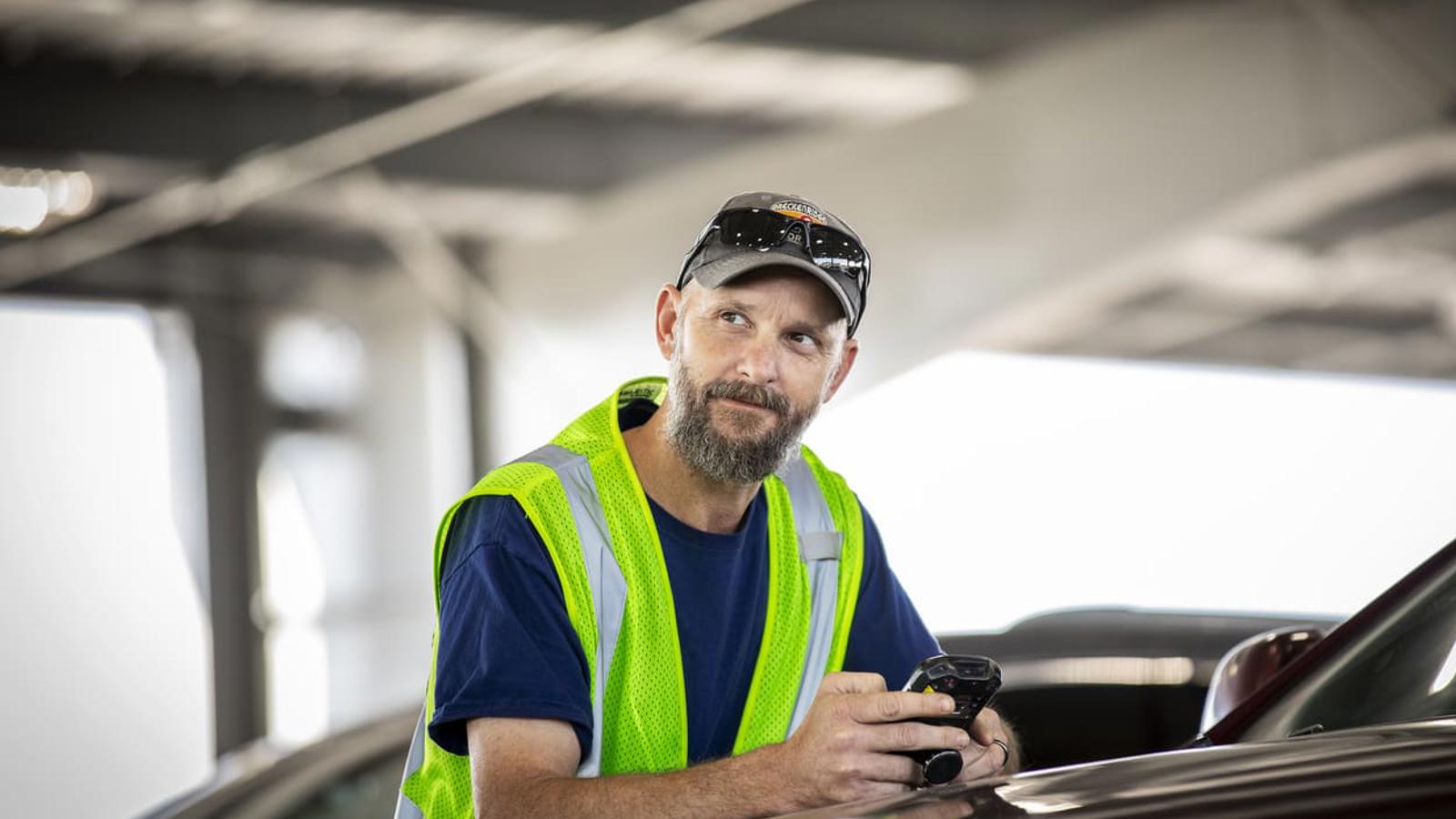 a person in a reflective vest holding a phone