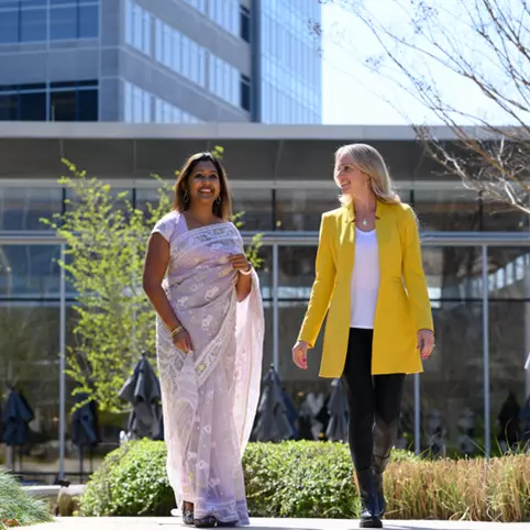 Cox employees walking outside Cox campus