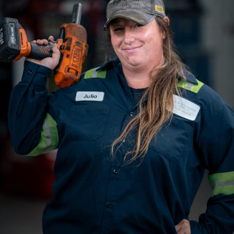 Cox automotive woman technician holding a tool