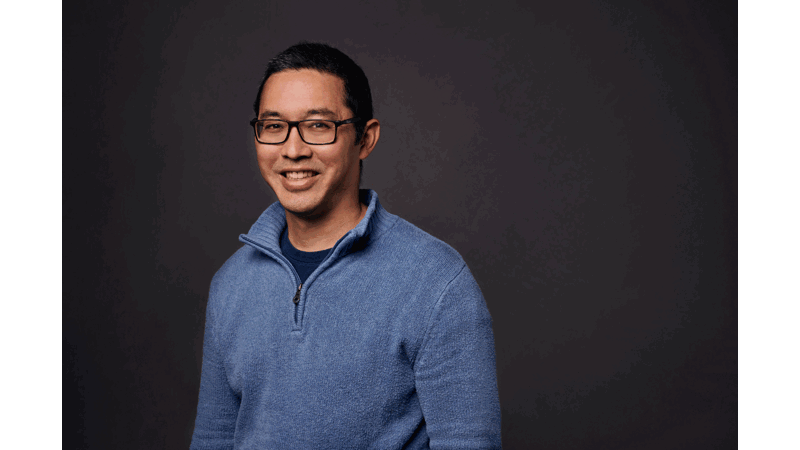 a person wearing glasses and a blue sweater