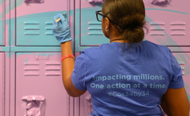 a person wearing a blue shirt and gloves