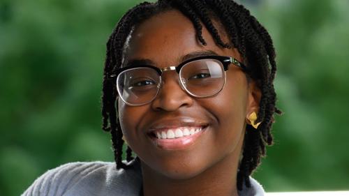 a person wearing glasses and smiling