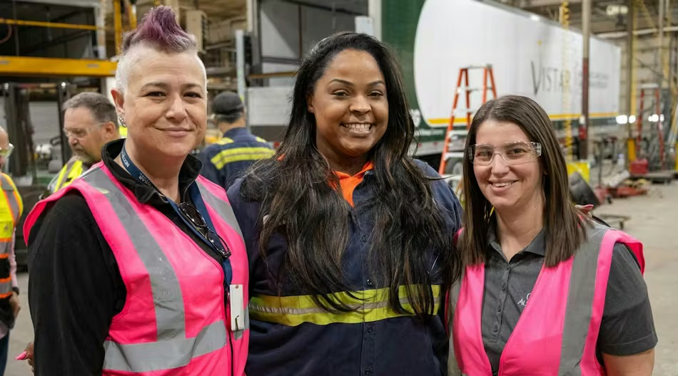 3 Cox employees wearing pink vests
