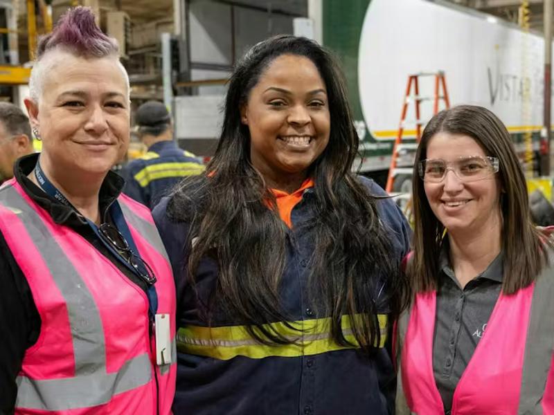 3 Cox employees wearing pink vests