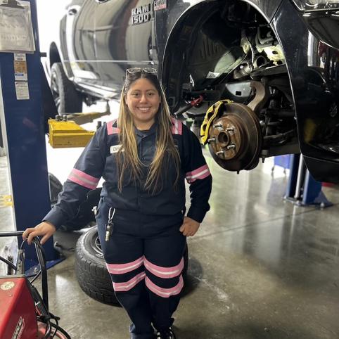 Cox Automotive Women Employee posing in front of car