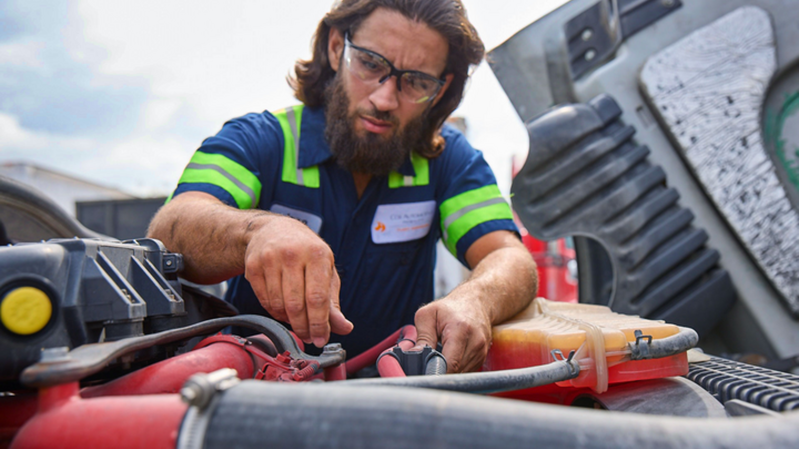 Cox Automotive mechanic working under hood of car
