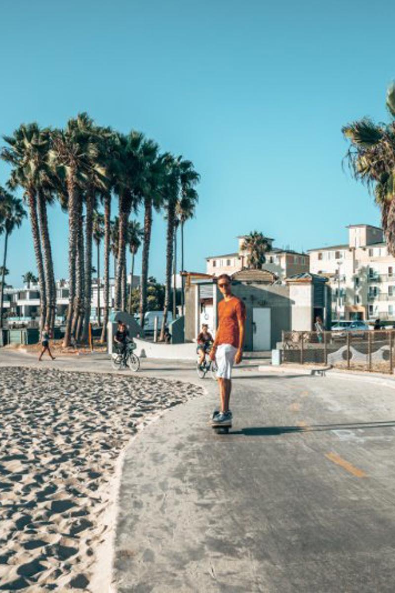 a person riding a skateboard on a beach