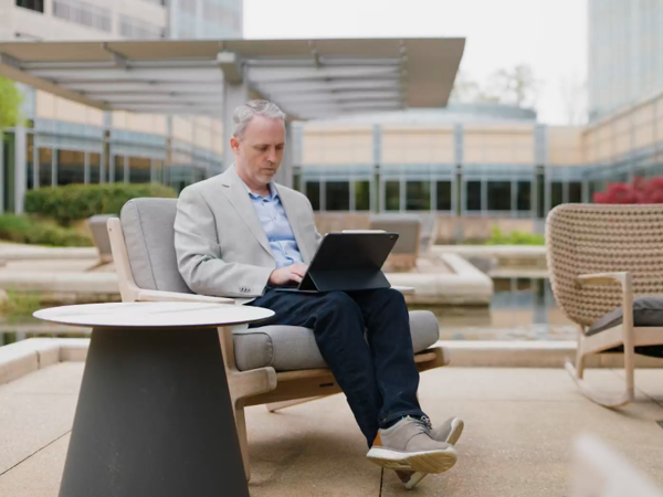 David Rice cox employee working on laptop by the ponds