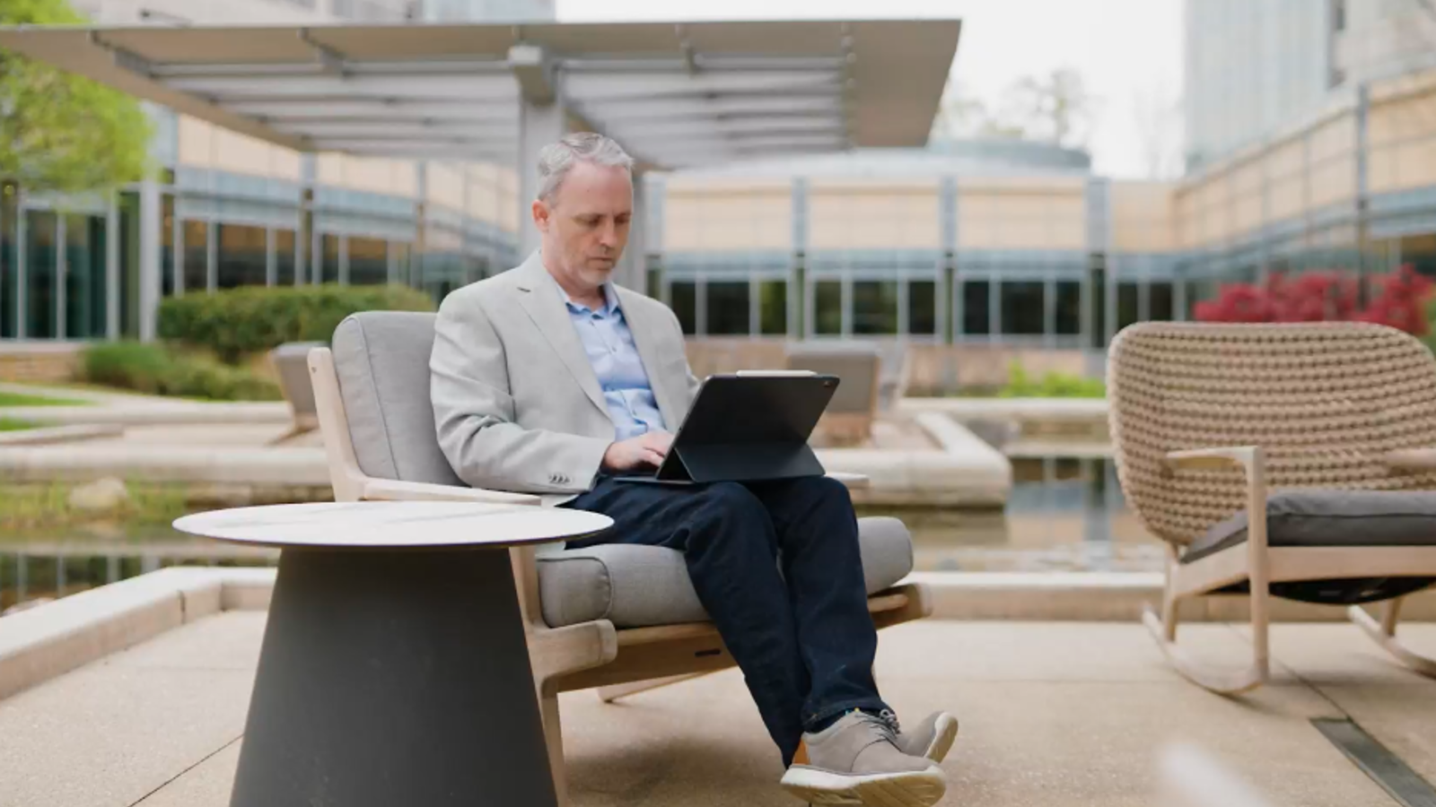 David Rice cox employee working on laptop by the ponds