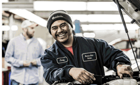 a Cox Automotive technician smiling at the camera