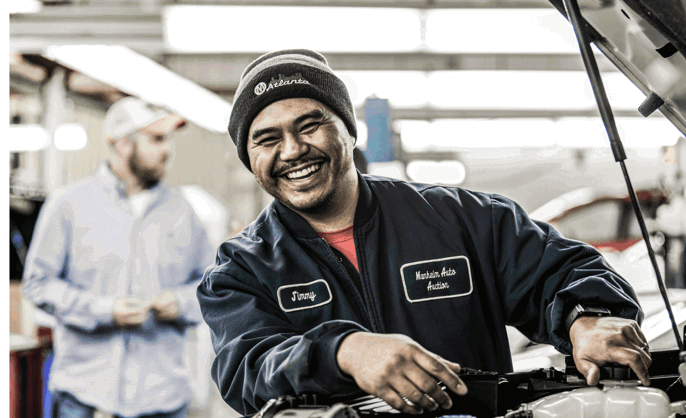 a Cox Automotive technician smiling at the camera