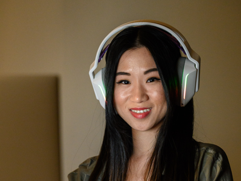 A cox employee wearing headphones and smiling