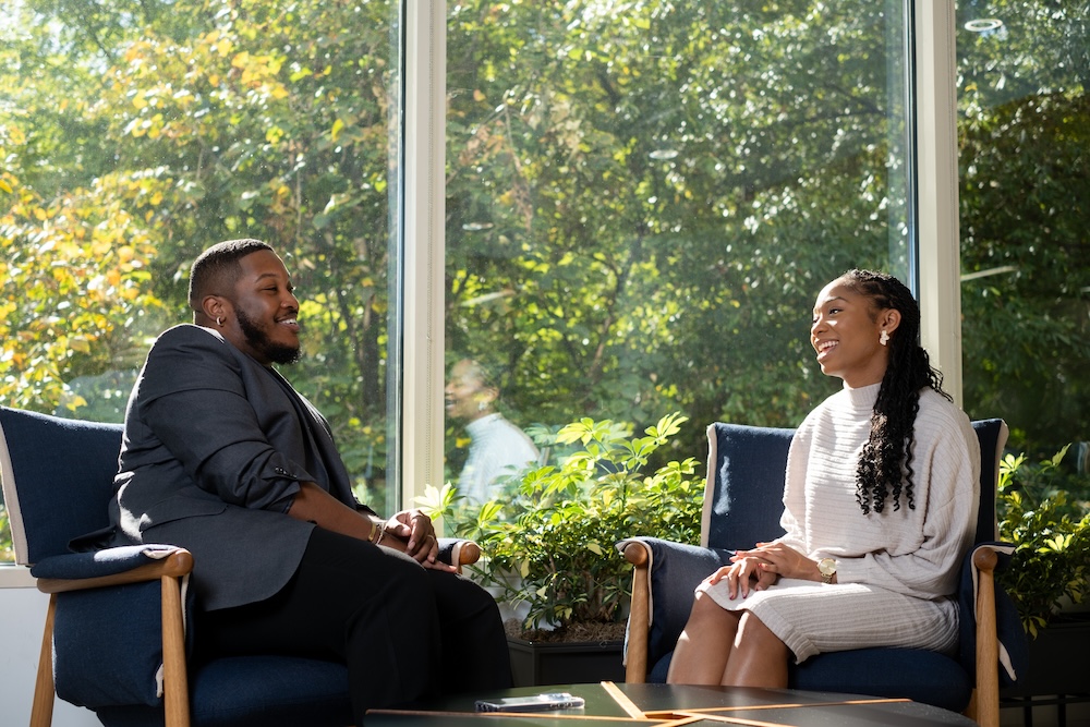 a person and person sitting in chairs
