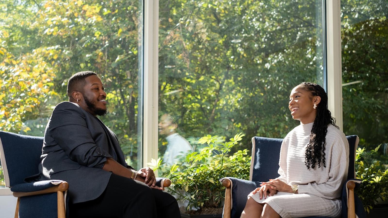 a person and person sitting in chairs