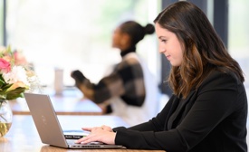 Cox Automotive employee working on laptop