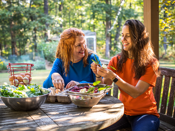 Cox employees preparing a salad