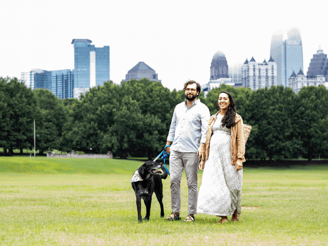 2 cox employees walking with their dog through atlanta