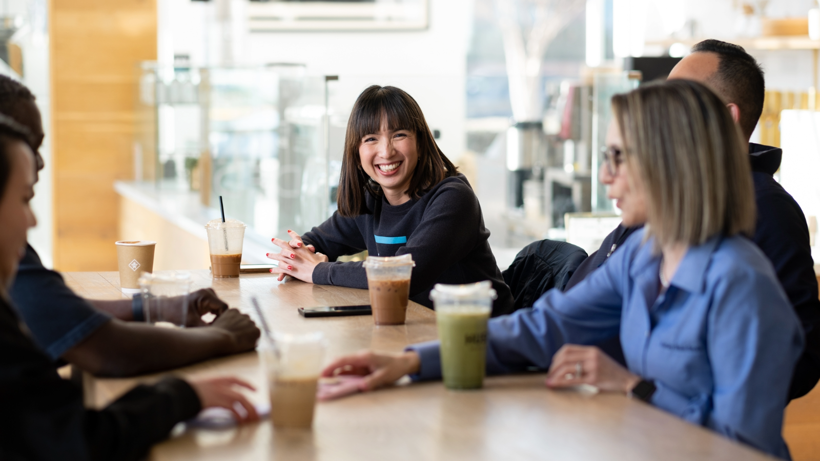 a group of women sitting at a table with drinks