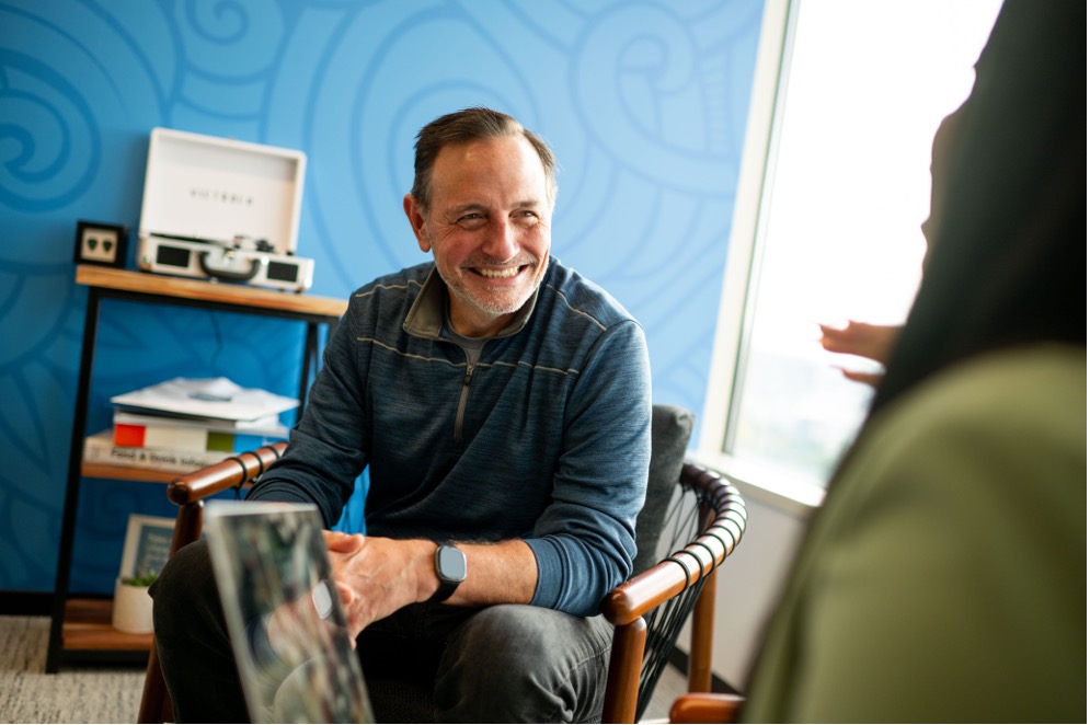 a person sitting in a chair smiling