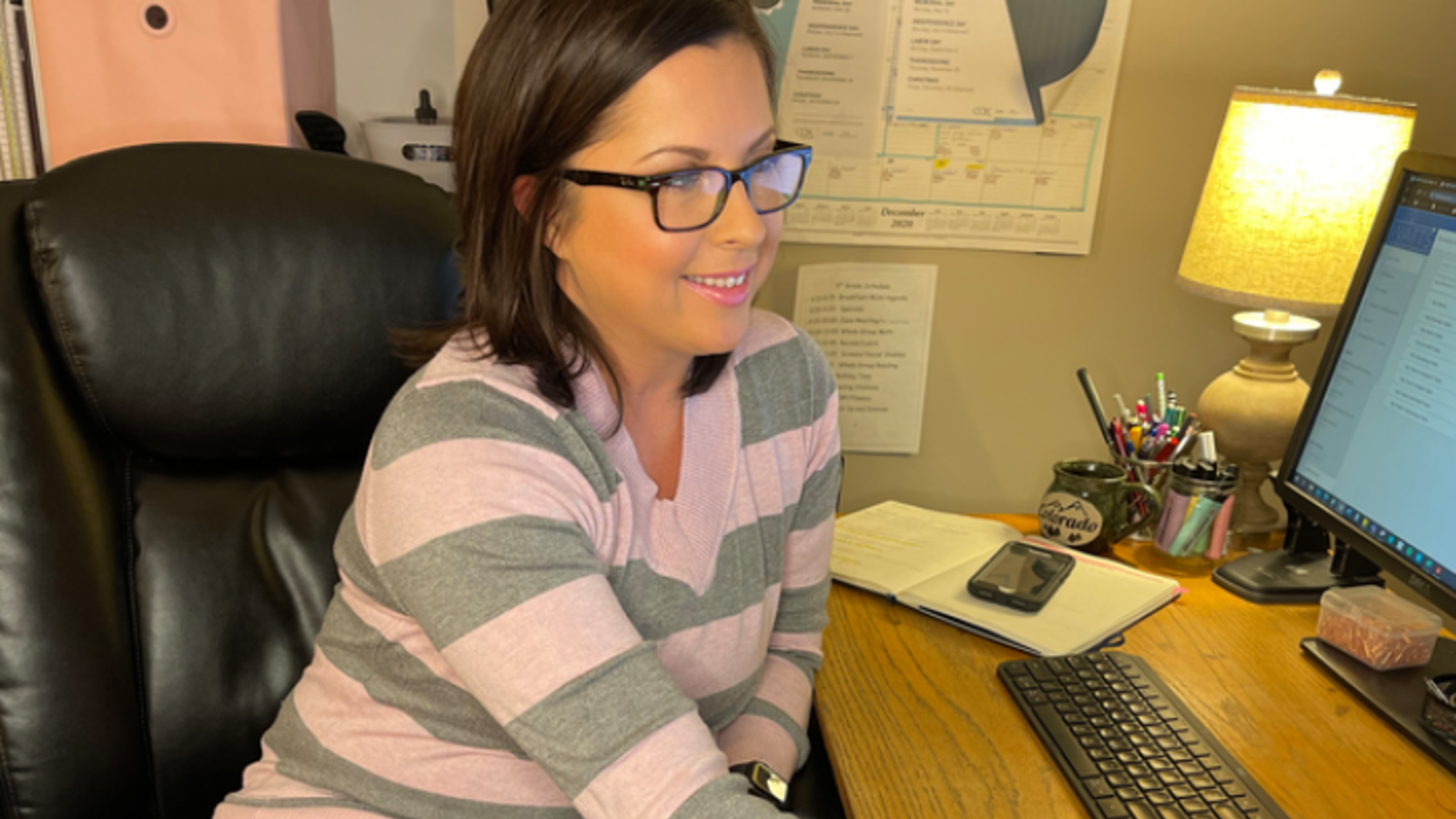 a Cox employee working on a computer from home