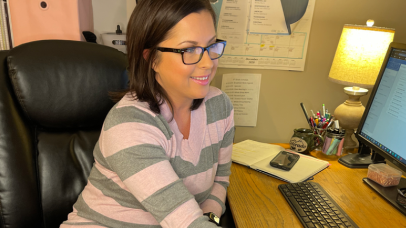 a Cox employee working on a computer from home