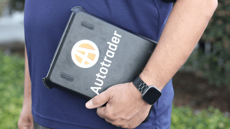 COx employee holding an Autotrader tablet