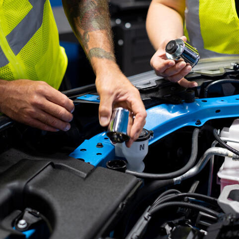 Cox women auto technicians fixing a car