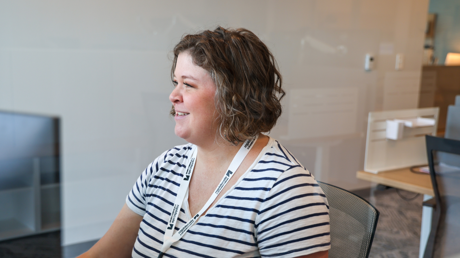 a person smiling in a striped shirt