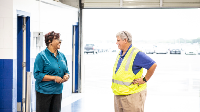 a Manheim general manager talking to another Cox employee at an auction site.