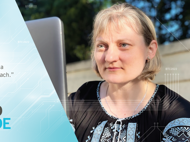 a Cox employee sitting in front of a laptop