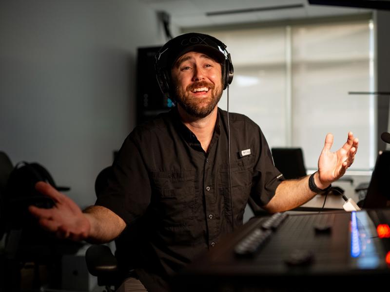 a person wearing headphones and smiling