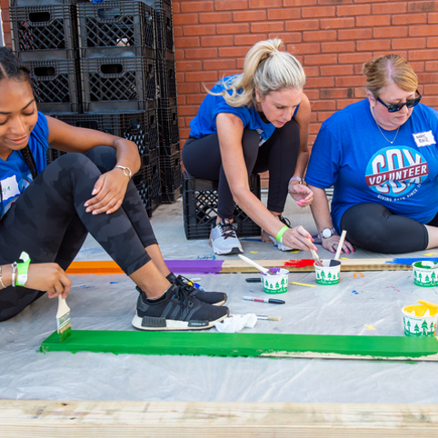 Cox employees volunteering and painting