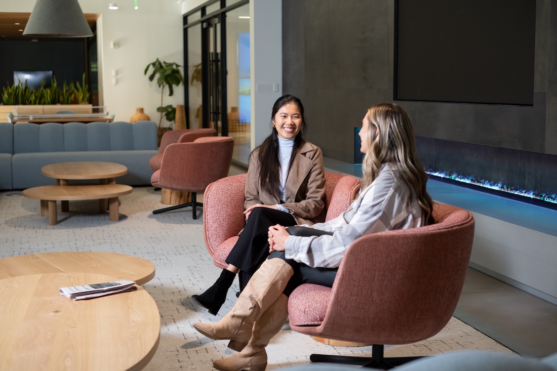 two women sitting in chairs