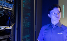 Segra employee standing in front of a server