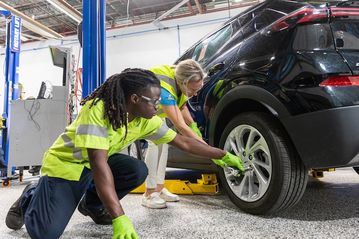 a person and a person working on a car