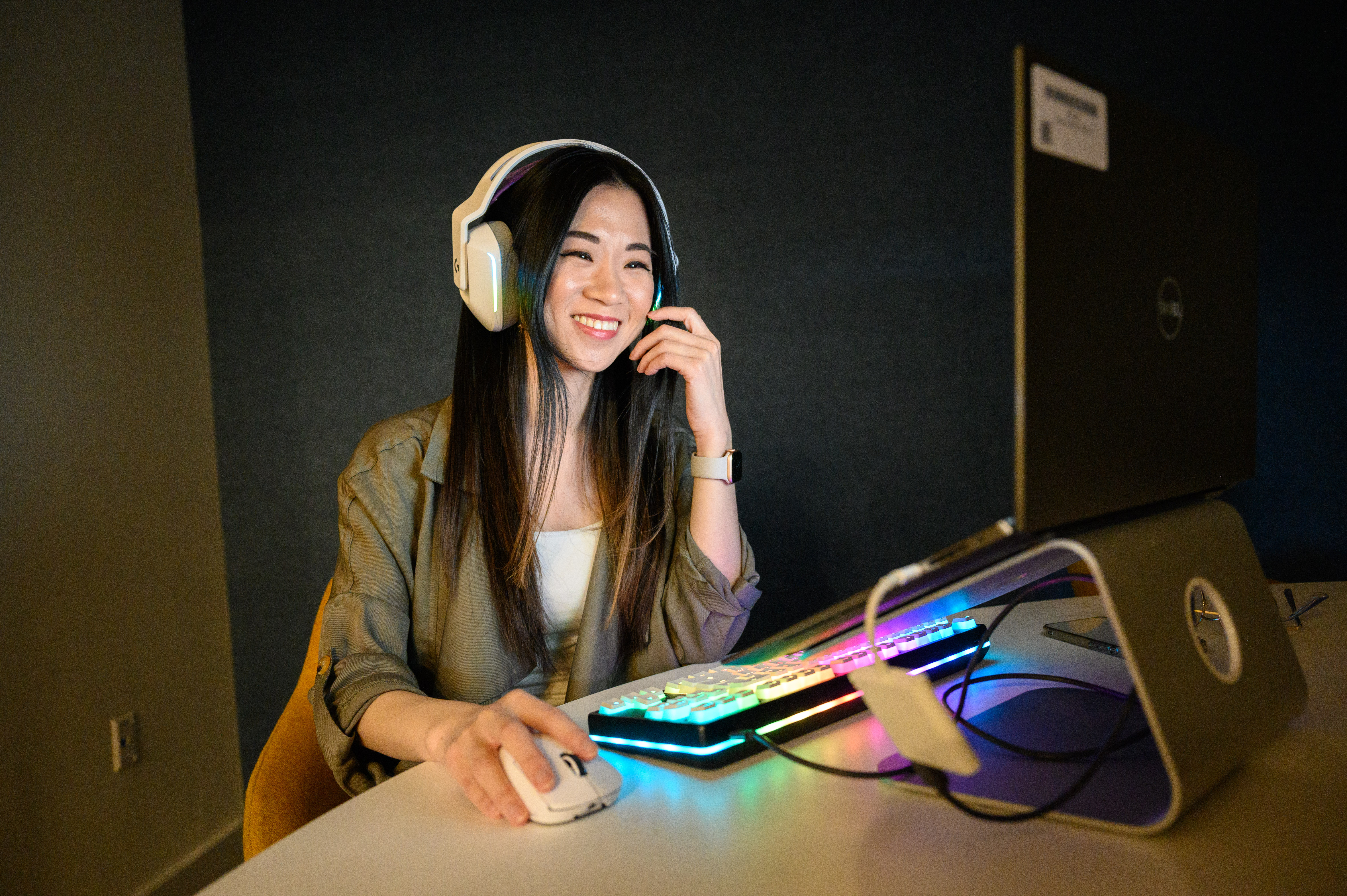a Cox employee wearing headphones and sitting at a desk with a computer