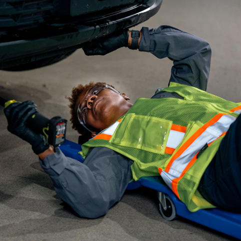 Cox automotive woman technician working on car