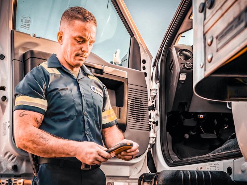a person in uniform looking at his phone