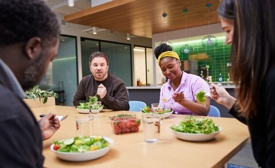 a group of Cox employees eating Cox Farms produce at a table