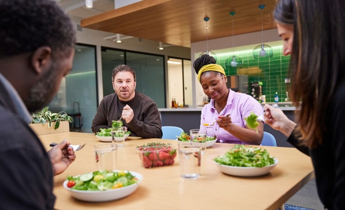 a group of Cox employees eating Cox Farms produce at a table