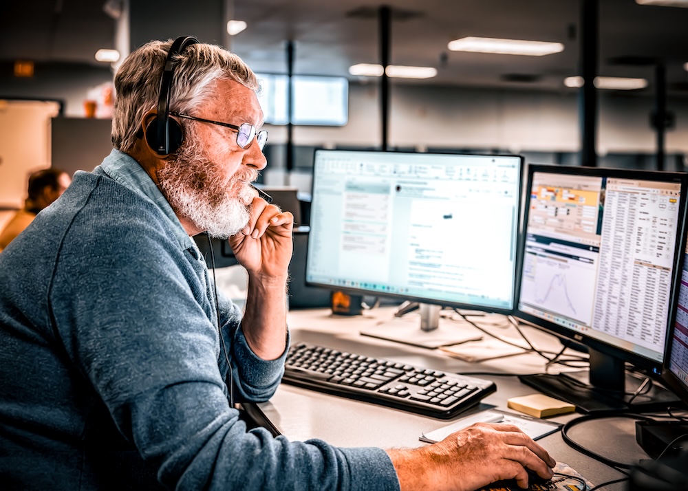 a person wearing headphones and using a computer