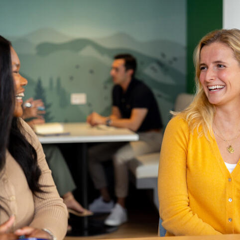two Cox employees sitting at a table
