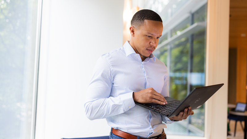 Cox employee on laptop
